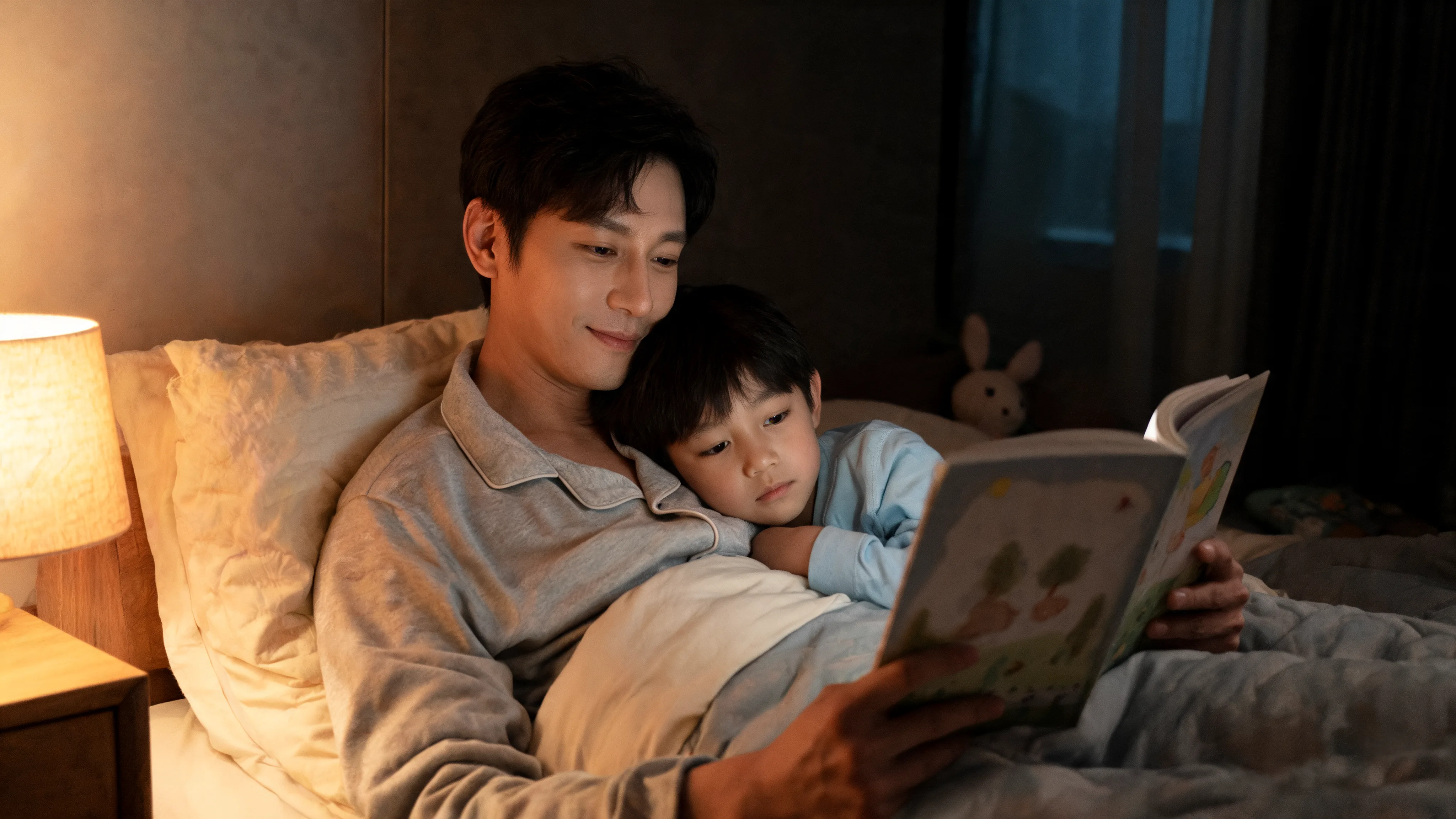 Why Reading With Your Child Builds a Stronger Parent-Child Bond Parent reading with a child at bedtime in warm light, building a close parent-child bond